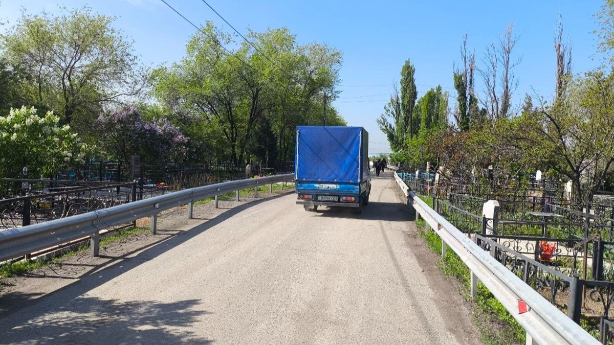 По дороге через кладбище проезжает грузовой автомобиль